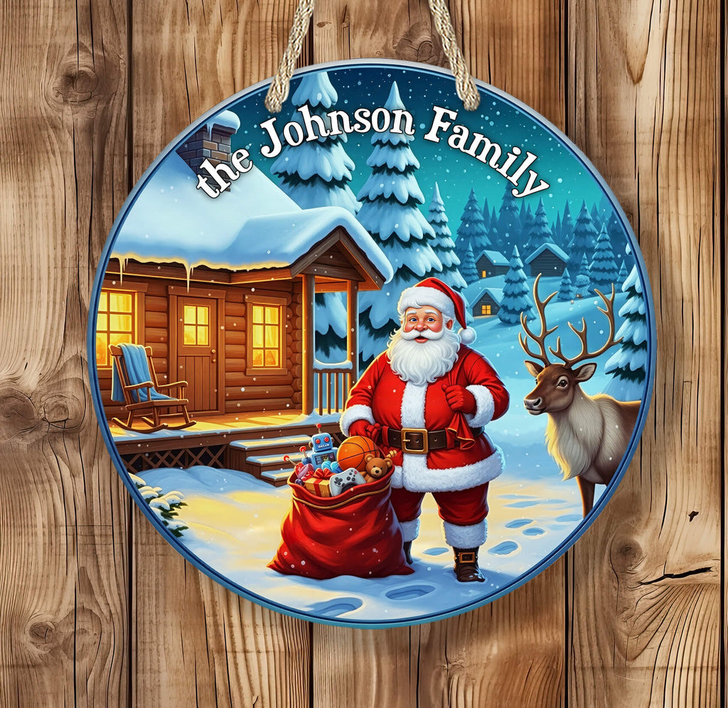 Decorative Christmas plaque with Santa Claus, reindeer, and a cabin scene on a wooden background.