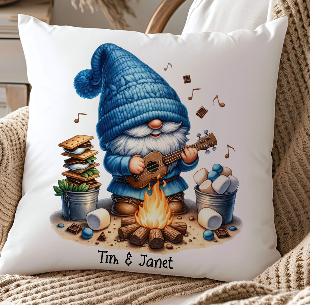 A personalized camping pillow featuring a cute gnome playing a guitar by a campfire, surrounded by marshmallows, chocolate, and s’mores ingredients. Available in 18x18 inches, white canvas or beige linen, with a hidden zipper closure. Perfect for camping lovers, rustic home decor, and cozy cabin retreats - Personalized Kreation