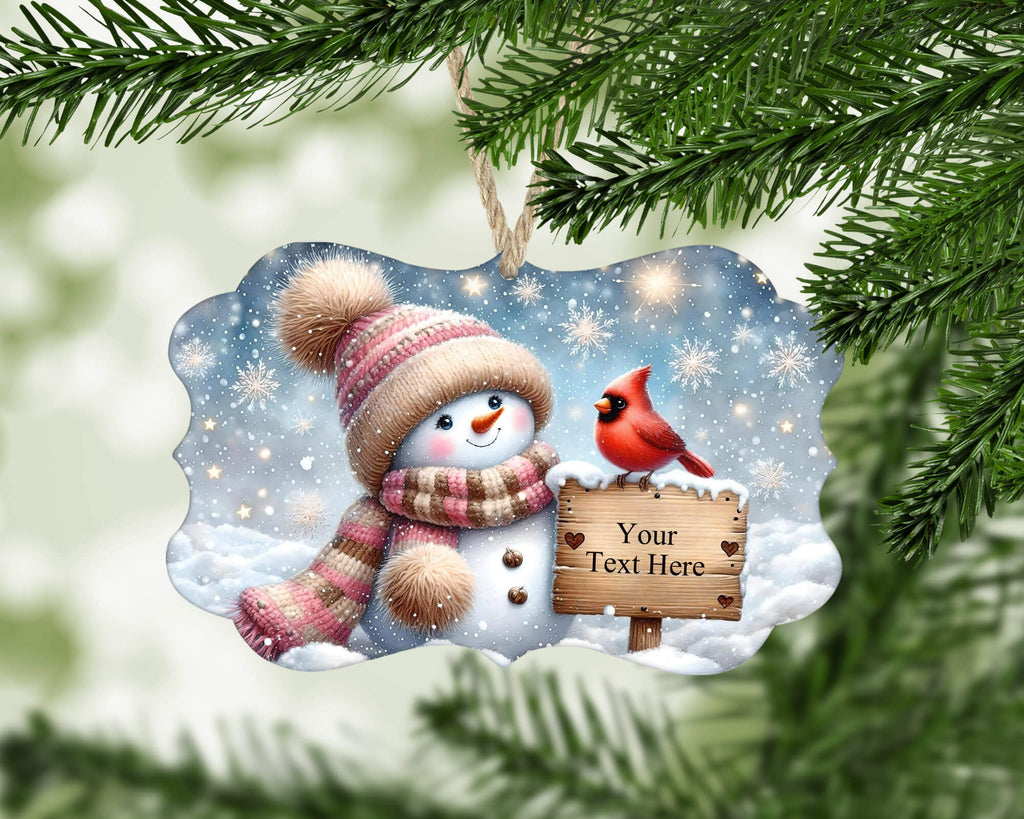 Christmas ornament with a snowman and cardinal bird holding a sign with 'Your Text Here' on a snowy background.