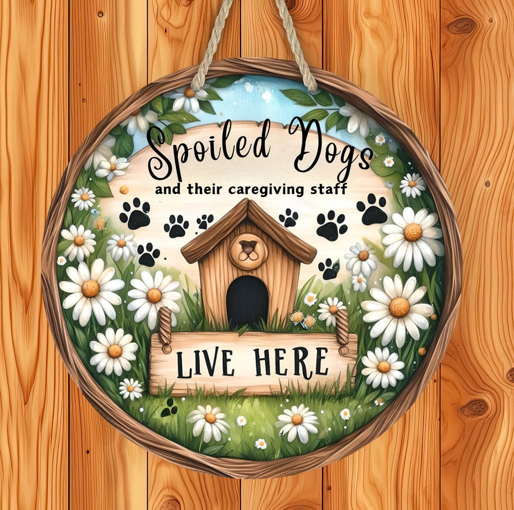 rustic hardboard 14 inch round dog sign featuring a cozy doghouse, paw prints, and white daisies with the phrase "Spoiled Dogs and Their Caregiving Staff Live Here," designed for pet lovers, farmhouse decor, and dog-friendly homes - Personalized Kreation