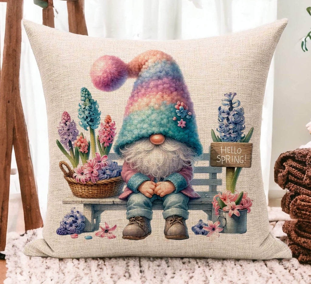 Spring Gnome Pillow with pastel colors featuring a gnome sitting on a wooden bench surrounded by blooming flowers a rustic Hello Spring sign and soft cottagecore aesthetics Available in 18x18 beige linen or white Easter gifts and farmhouse accents - Personalized Kreation