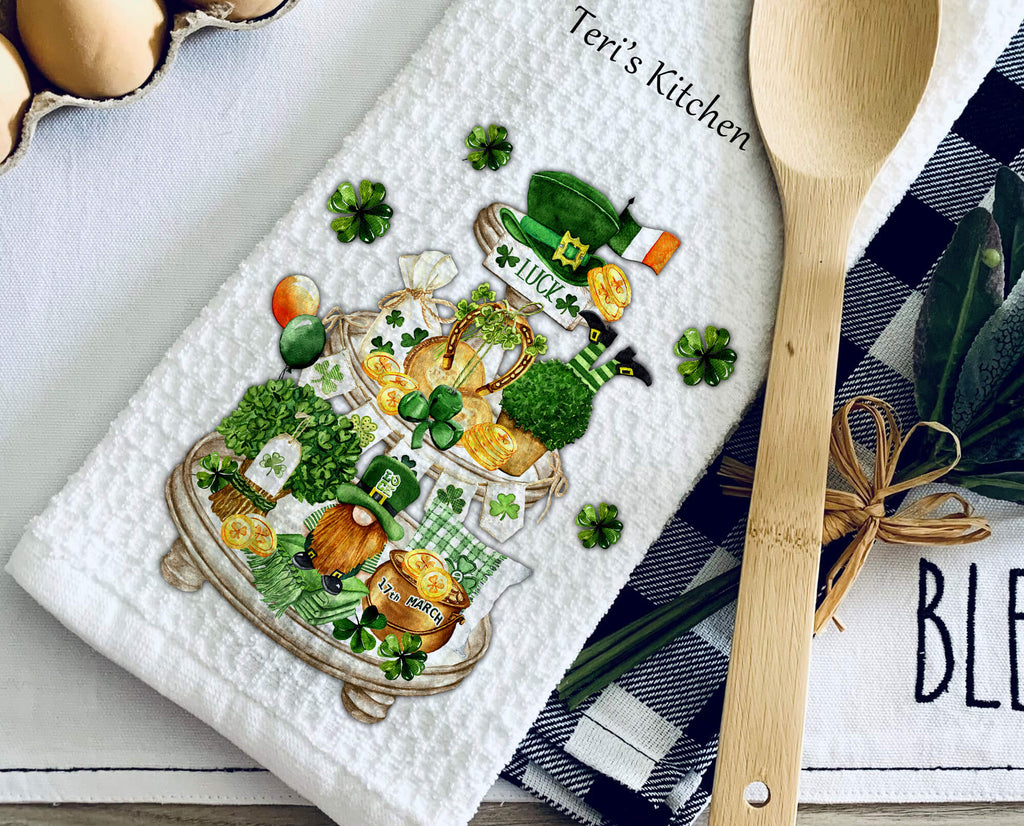 St. Patrick’s Day kitchen towel with tiered tray design featuring shamrocks, leprechaun, gold coins, and festive Irish decor. Perfect farmhouse kitchen decor or lucky holiday gift. Personalized St. Patrick’s Day tea towel for home and celebrations