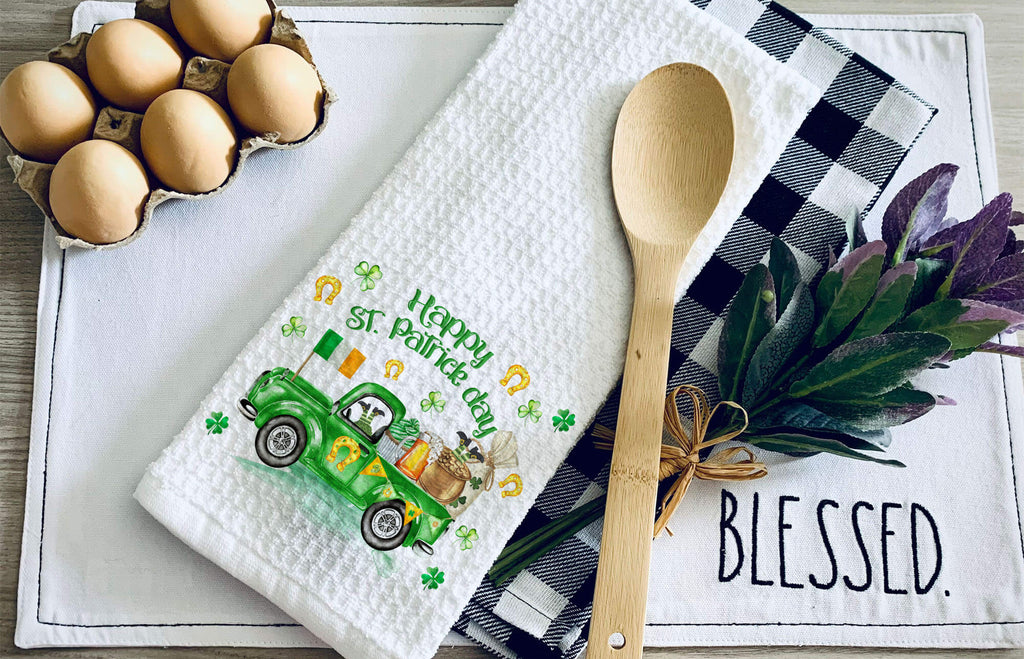 St. Patrick’s Day kitchen towel featuring a green Irish truck with shamrocks, gold coins, and festive decorations. Perfect holiday dish towel for farmhouse kitchens, St. Paddy’s decor, or a lucky housewarming gift. Soft, absorbent, and machine washable