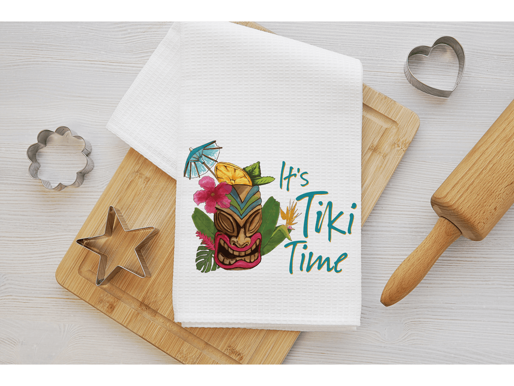 It's Tiki Time kitchen towel featuring a vibrant tiki mask design with tropical flowers and cocktail umbrella, perfect for tiki bar décor, luau parties, and summer kitchen accents - Personalized Kreation