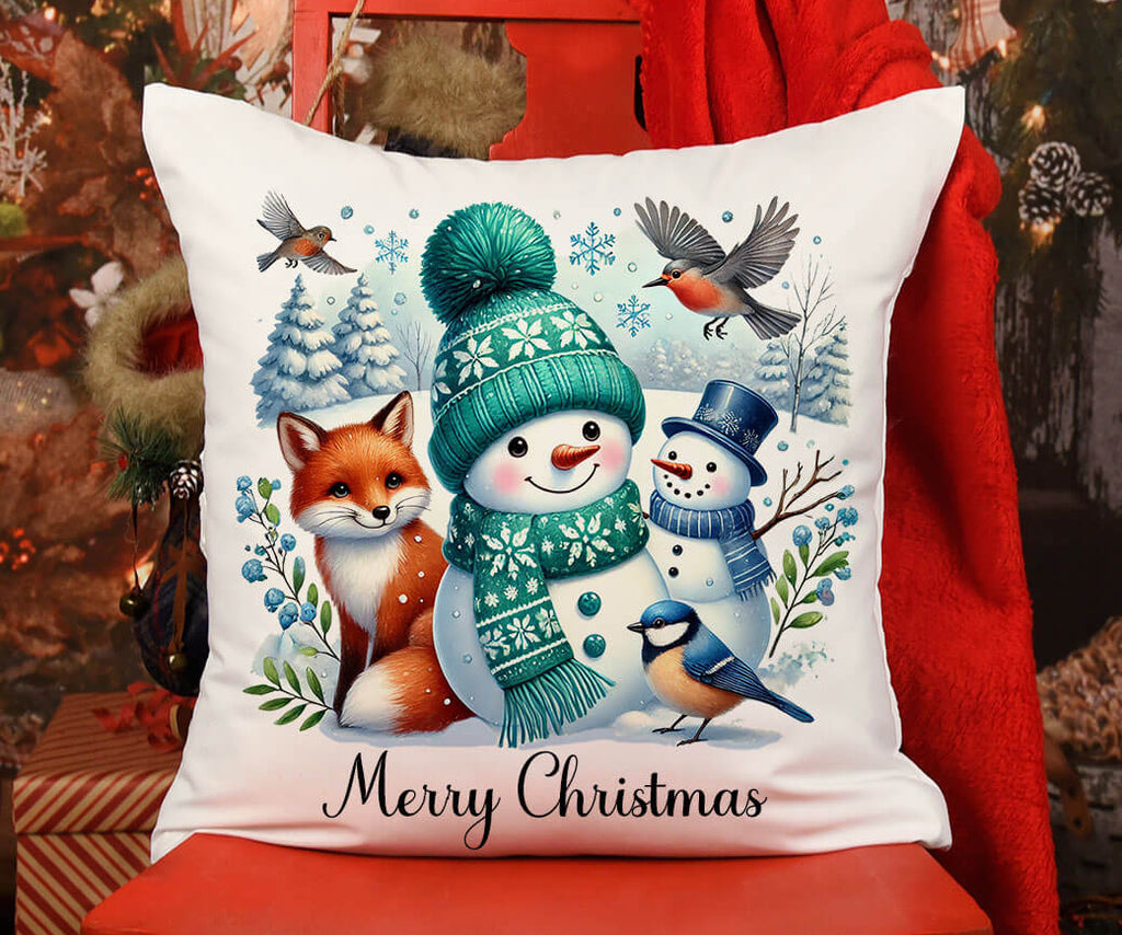 Decorative pillow with winter scene design featuring snowman, fox, and birds on a red chair.